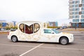 car limousine carriage form in parking. heart shape limousine window. white with gold pattern wedding car limousine side view.