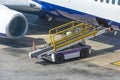 Car for loading luggage compartment of the aircraft is ready, waiting for cargo Royalty Free Stock Photo