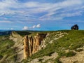 The car is located next to two monks rocks in the cloud, Bermamyt Plateau, Karachay-Cherkess Republic.