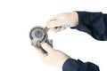 A car locksmith holds a spent old timing belt tensioner roller on a white background, isolate. Timing Belt Roller