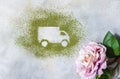 Car made of green powder and rose on a light background. Online shopping. Flowers delivery concept Royalty Free Stock Photo