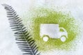 A car made of green powder and the shadow of plants on a light background. Online shopping. Flowers delivery concept Royalty Free Stock Photo