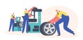 Car Maintenance and Fixing Service. Workers Change Automobile Tires at Garage. Male Characters Wear Uniform Mount Tyres