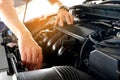 Car maintenance technician He is checking the auto engine, car inspection center