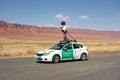 A car mapping a road in the desert as seen parked at the vermillion cliffs