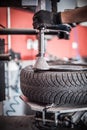 Car master mechanic vulcanizer repairing tire on auto vulcanizing machine Royalty Free Stock Photo