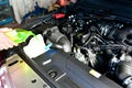 Car mechanic changes coolant on the vehicle