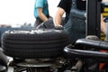 Car mechanic changind tires of a car