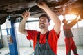 Profecional car mechanic changing motor oil at maintenance repair service station Royalty Free Stock Photo