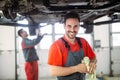 Profecional car mechanic changing motor oil at maintenance repair service station Royalty Free Stock Photo