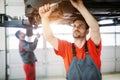 Profecional car mechanic changing motor oil at maintenance repair service station Royalty Free Stock Photo
