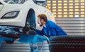 Car mechanic changing tire in his workshop Royalty Free Stock Photo