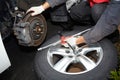 Car mechanic changing tire. Royalty Free Stock Photo