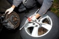 Car mechanic changing tire. Royalty Free Stock Photo