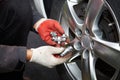 Car mechanic changing tire. Royalty Free Stock Photo