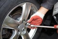 Car mechanic changing tire. Royalty Free Stock Photo