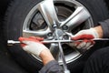 Car mechanic changing tire. Royalty Free Stock Photo