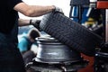 Car mechanic changing tires of a car in a repair shop