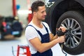 Car mechanic changing tires Royalty Free Stock Photo