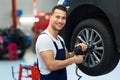 Car mechanic changing tires Royalty Free Stock Photo