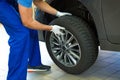 Car mechanic changing tires