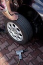 Car mechanic changing wheel Royalty Free Stock Photo