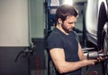 Mechanic changing car wheel in auto repair garage