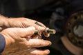 Car mechanic changing car wheel and tire by wrench at car garage in Bucharest, Romania, 2021 Royalty Free Stock Photo