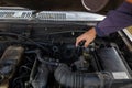 car mechanic is checking condition of engine to make it ready for use and mechanic is still maintaining worn out equipment to