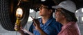 Car mechanic checking and maintenace car in service under supervision of senior mechanic Royalty Free Stock Photo