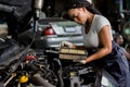 Car mechanic checking  oil quality the engine motor car Transmission and Maintenance Gear. car mechanic in an auto repair shop is Royalty Free Stock Photo