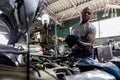 Car mechanic checking  oil quality the engine motor car Transmission and Maintenance Gear. car mechanic in an auto repair shop is Royalty Free Stock Photo