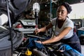 Car mechanic checking  oil quality the engine motor car Transmission and Maintenance Gear. car mechanic in an auto repair shop is Royalty Free Stock Photo