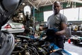 Car mechanic checking  oil quality the engine motor car Transmission and Maintenance Gear. car mechanic in an auto repair shop is Royalty Free Stock Photo