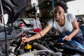 Car mechanic checking  oil quality the engine motor car Transmission and Maintenance Gear. car mechanic in an auto repair shop is Royalty Free Stock Photo