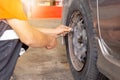 Car mechanic checking tyre pressure work at repair service station Royalty Free Stock Photo