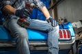 Car Mechanic with Cordless Powertool in His Hand and His Next Project Royalty Free Stock Photo