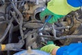 a car mechanic disassembles a car,a man repairs under the hood of a car Royalty Free Stock Photo