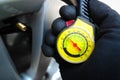 Car mechanic or driver checks tire pressure with a car tire pressure gauge. Royalty Free Stock Photo