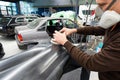 Car mechanic grinds a car part in handicraft in a service station - Serie car repair workshop