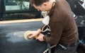 Car mechanic grinds a car part in handicraft in a service station - Serie car repair workshop