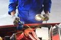 Car mechanic examining car using flashlight checking oil in auto repair service