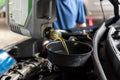 Car mechanic fills a fresh lubricant engine oil Royalty Free Stock Photo