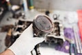 Car mechanic in garage with old car engine piston. Royalty Free Stock Photo