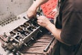 Car mechanic in garage with old car engine piston And valve Royalty Free Stock Photo