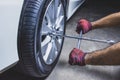 Car mechanic hand using cross wrench. Royalty Free Stock Photo