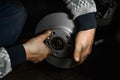 Car mechanic hands installing new car brake discs. Royalty Free Stock Photo