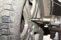 Car mechanic hands replace tires on wheels in garage. Mechanic technician worker installing car wheel at maintenance. Tire install