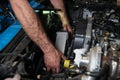 Car mechanic hands replacing intercooler on a car engine. Royalty Free Stock Photo