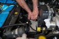 Car mechanic hands replacing intercooler on a car engine. Royalty Free Stock Photo